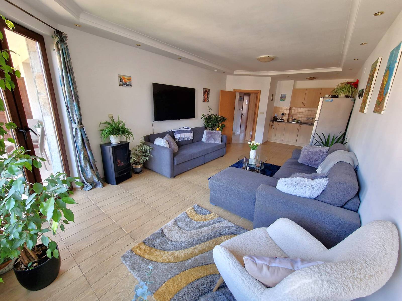 A modern, cozy two bedroom apartment with new furniture and a frontal view of the Pirin Mountains