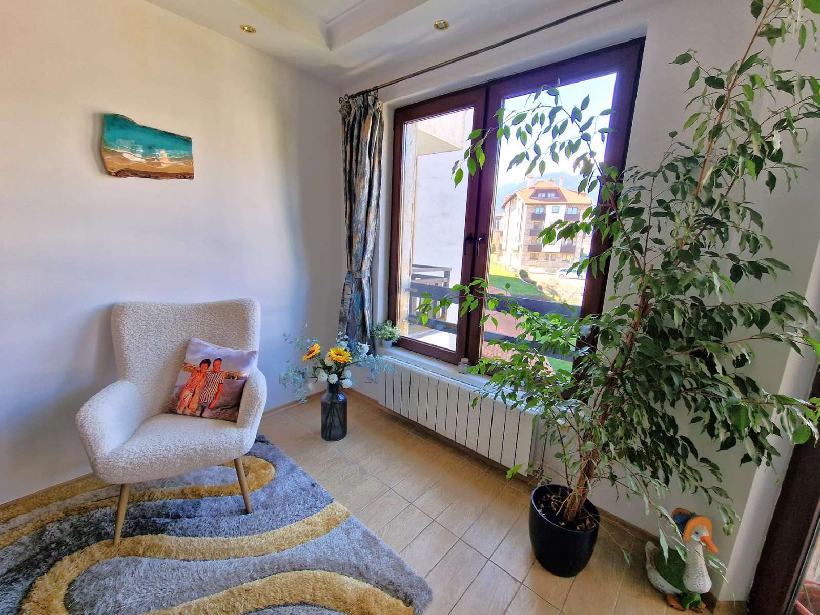 A modern, cozy two bedroom apartment with new furniture and a frontal view of the Pirin Mountains