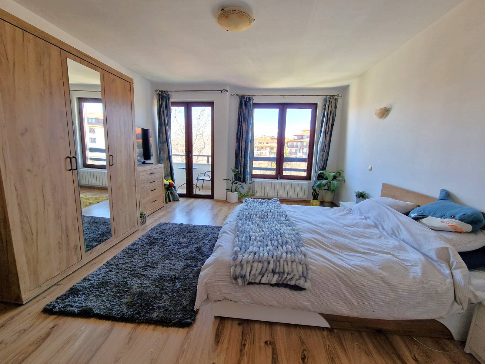 A modern, cozy two bedroom apartment with new furniture and a frontal view of the Pirin Mountains