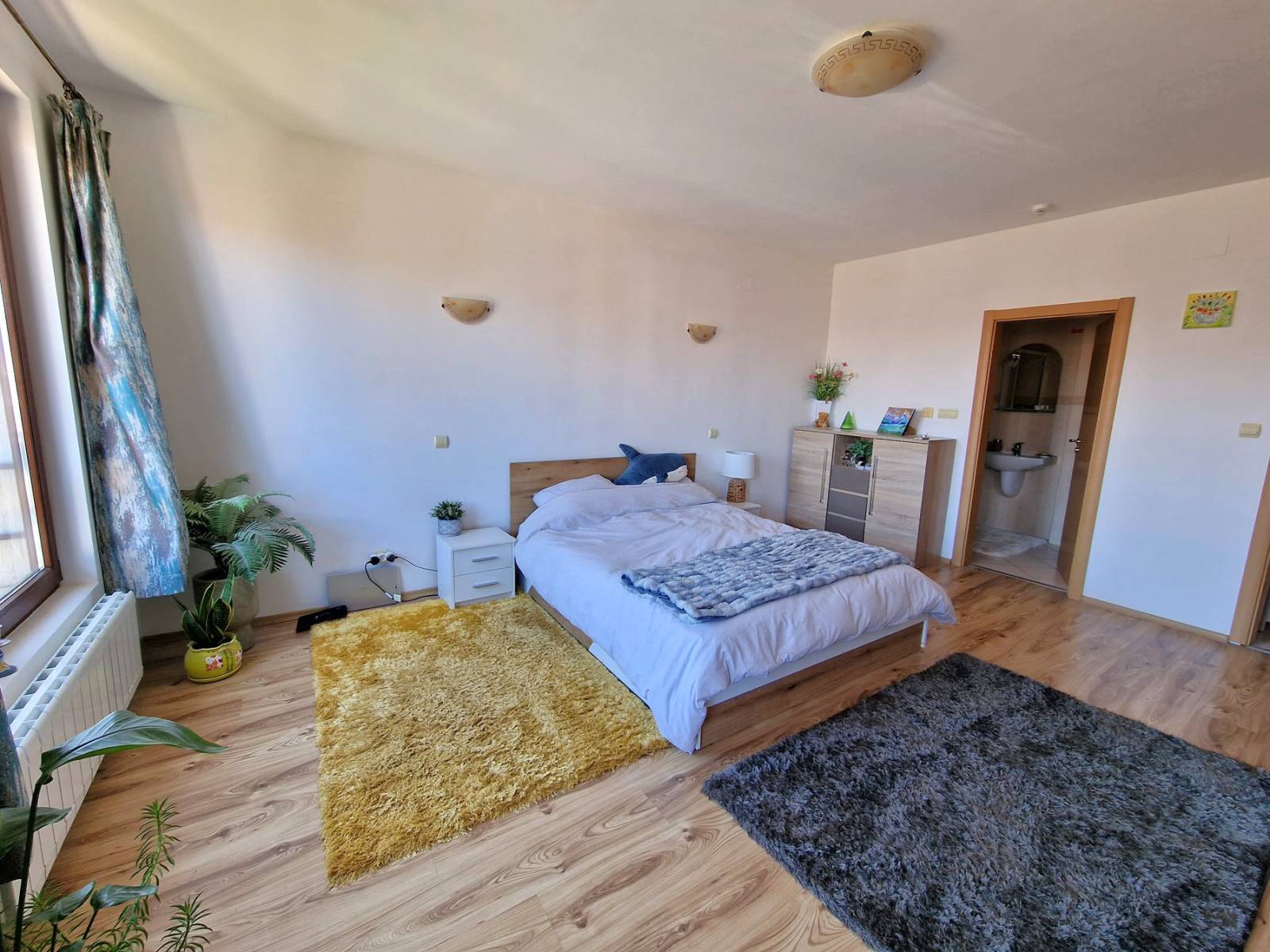 A modern, cozy two bedroom apartment with new furniture and a frontal view of the Pirin Mountains