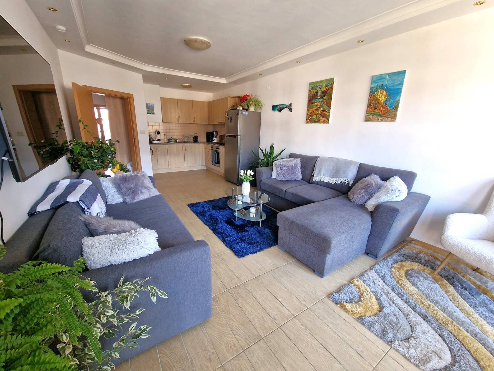 A modern, cozy two bedroom apartment with new furniture and a frontal view of the Pirin Mountains