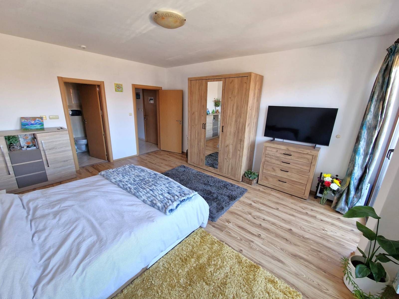 A modern, cozy two bedroom apartment with new furniture and a frontal view of the Pirin Mountains