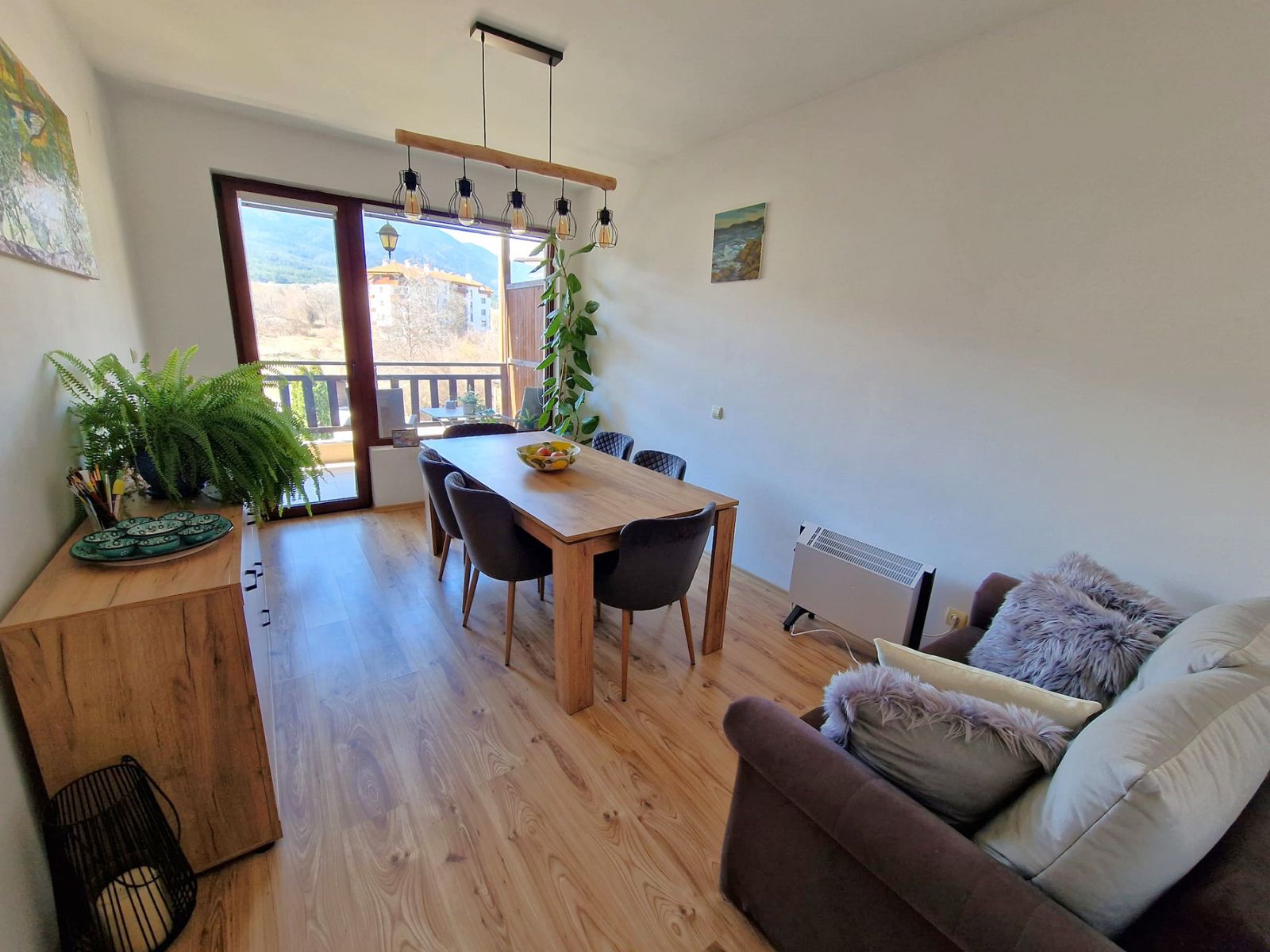 A modern, cozy two bedroom apartment with new furniture and a frontal view of the Pirin Mountains