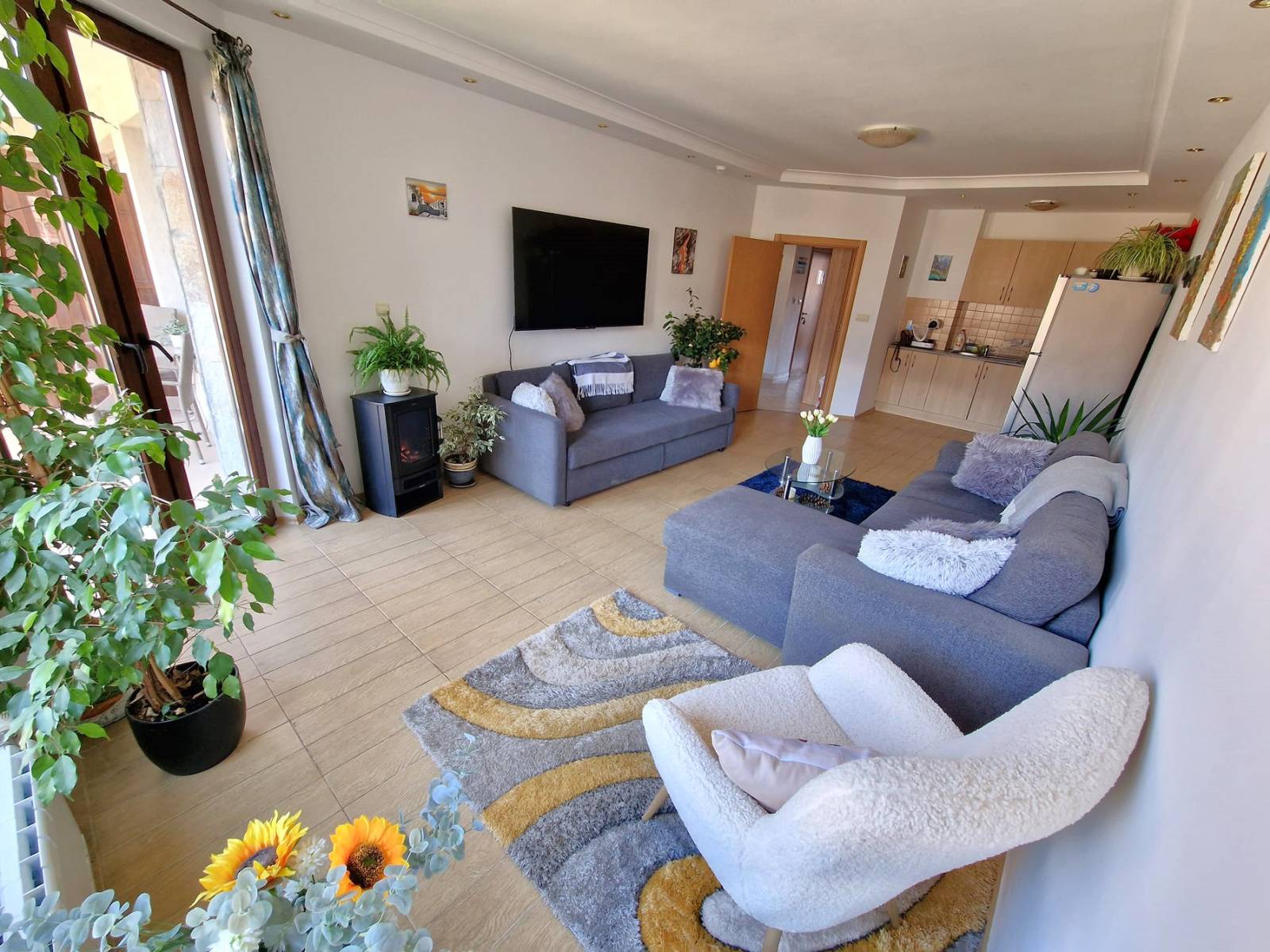 A modern, cozy two bedroom apartment with new furniture and a frontal view of the Pirin Mountains
