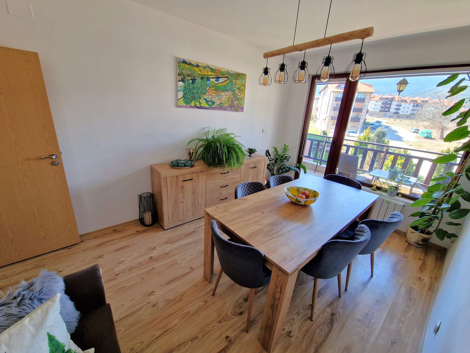 A modern, cozy two bedroom apartment with new furniture and a frontal view of the Pirin Mountains