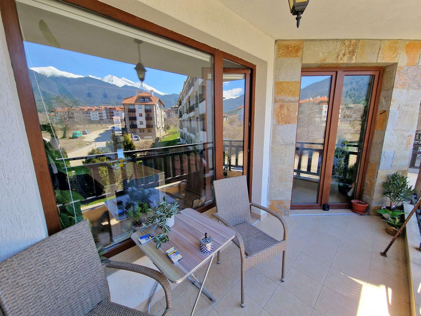 A modern, cozy two bedroom apartment with new furniture and a frontal view of the Pirin Mountains